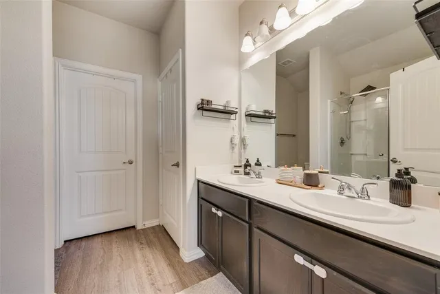 a bedroom with a bed a flat screen tv and dresser