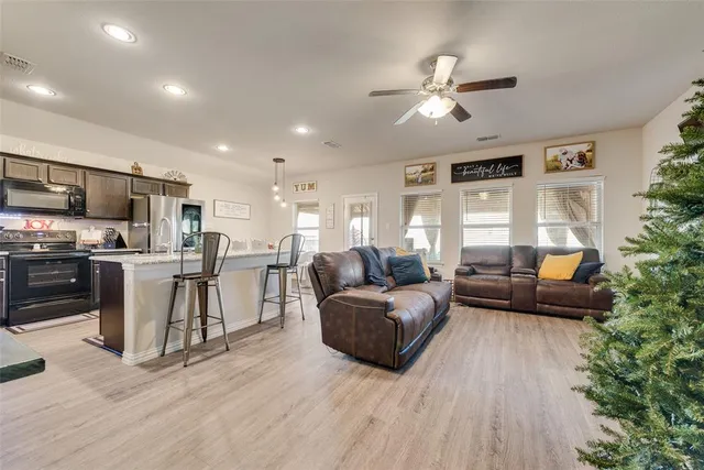 a view of a house with a yard and sitting area