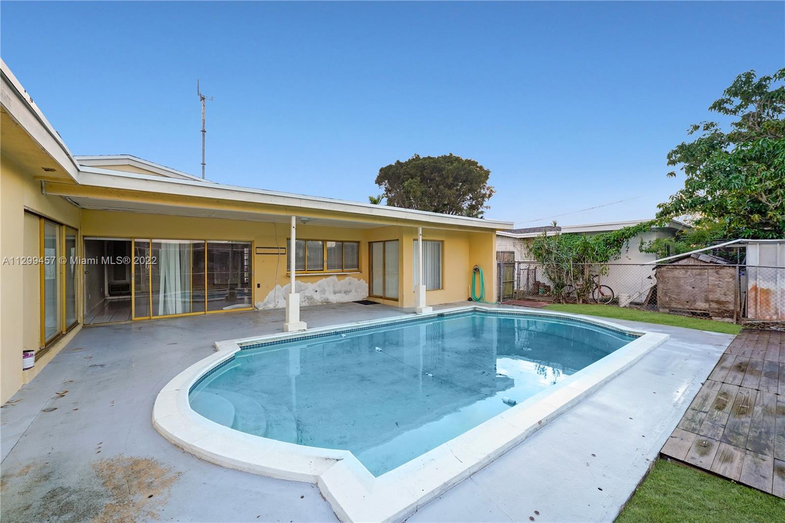 6745 Pansy Drive Miramar, FL 33023 - Photo 27 of 33 a view of a house with pool fire pit and furniture
