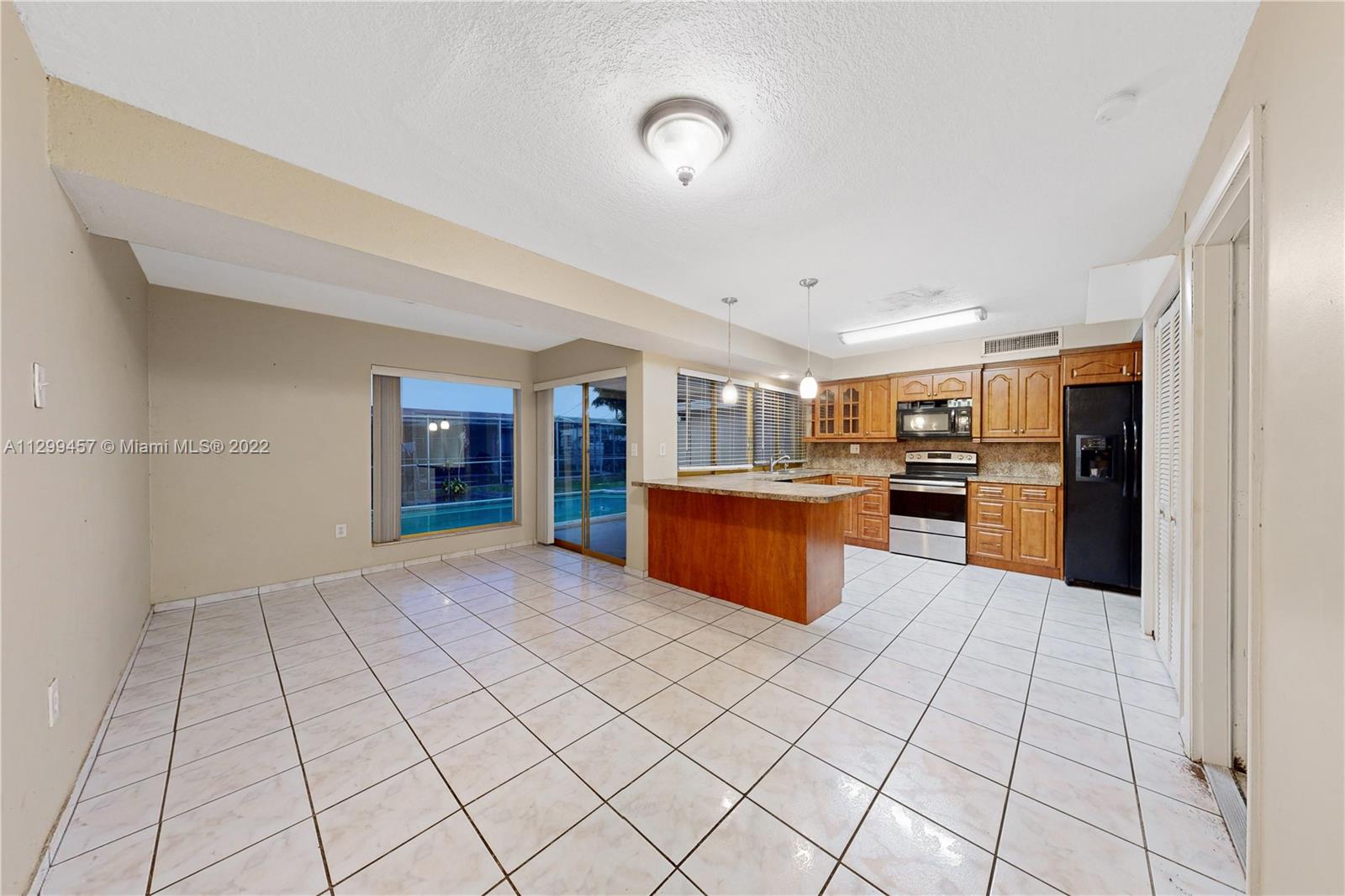 6745 Pansy Drive Miramar, FL 33023 - Photo 10 of 33 a kitchen with stainless steel appliances granite countertop a refrigerator and a sink