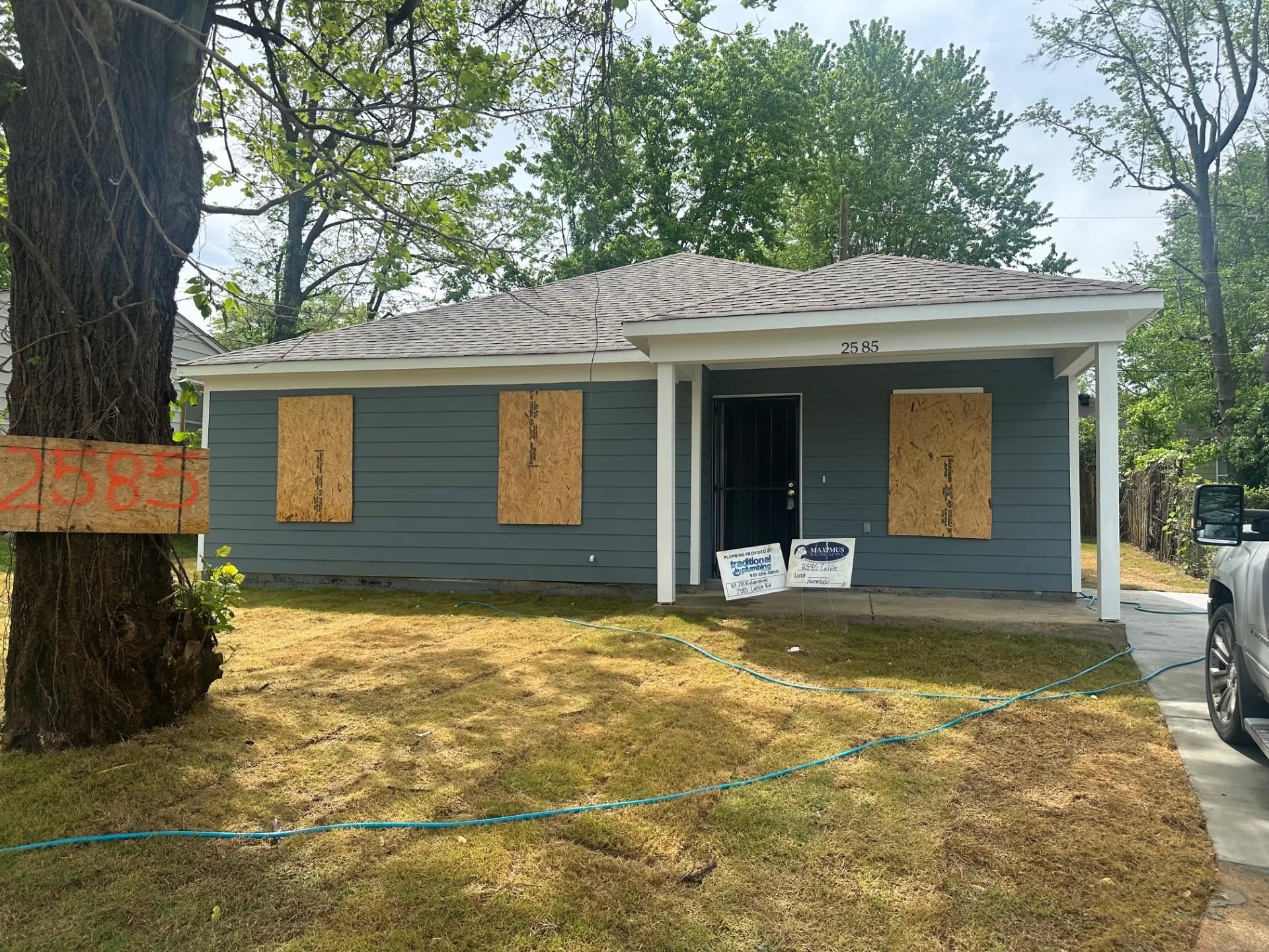 2585 Callie Road Memphis, TN 38127 - Photo 1 of 13 Rear view of property with a lawn and a shingled roof