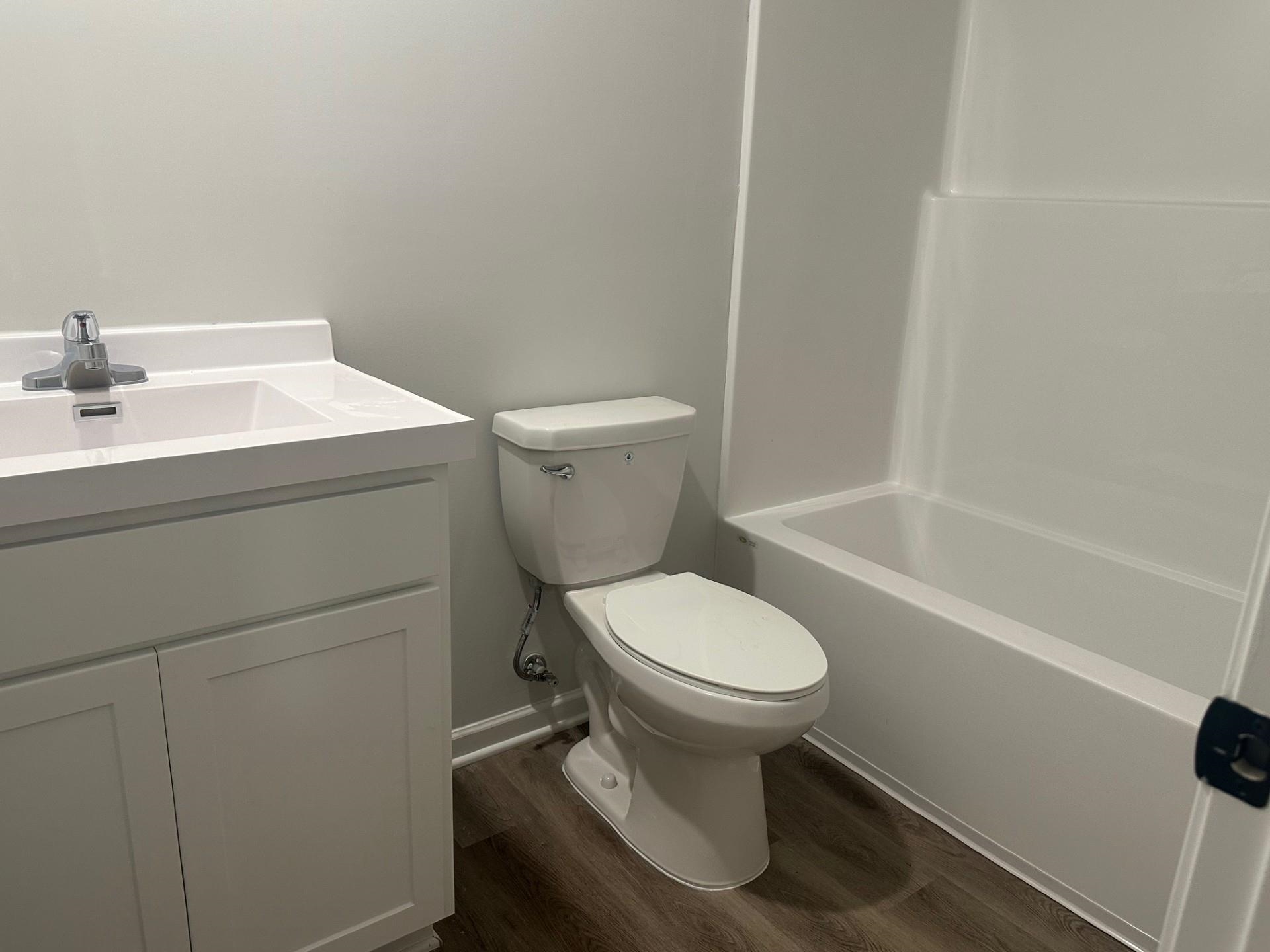 2585 Callie Road Memphis, TN 38127 - Photo 13 of 13 Bathroom featuring baseboards, wood finished floors, vanity, and toilet
