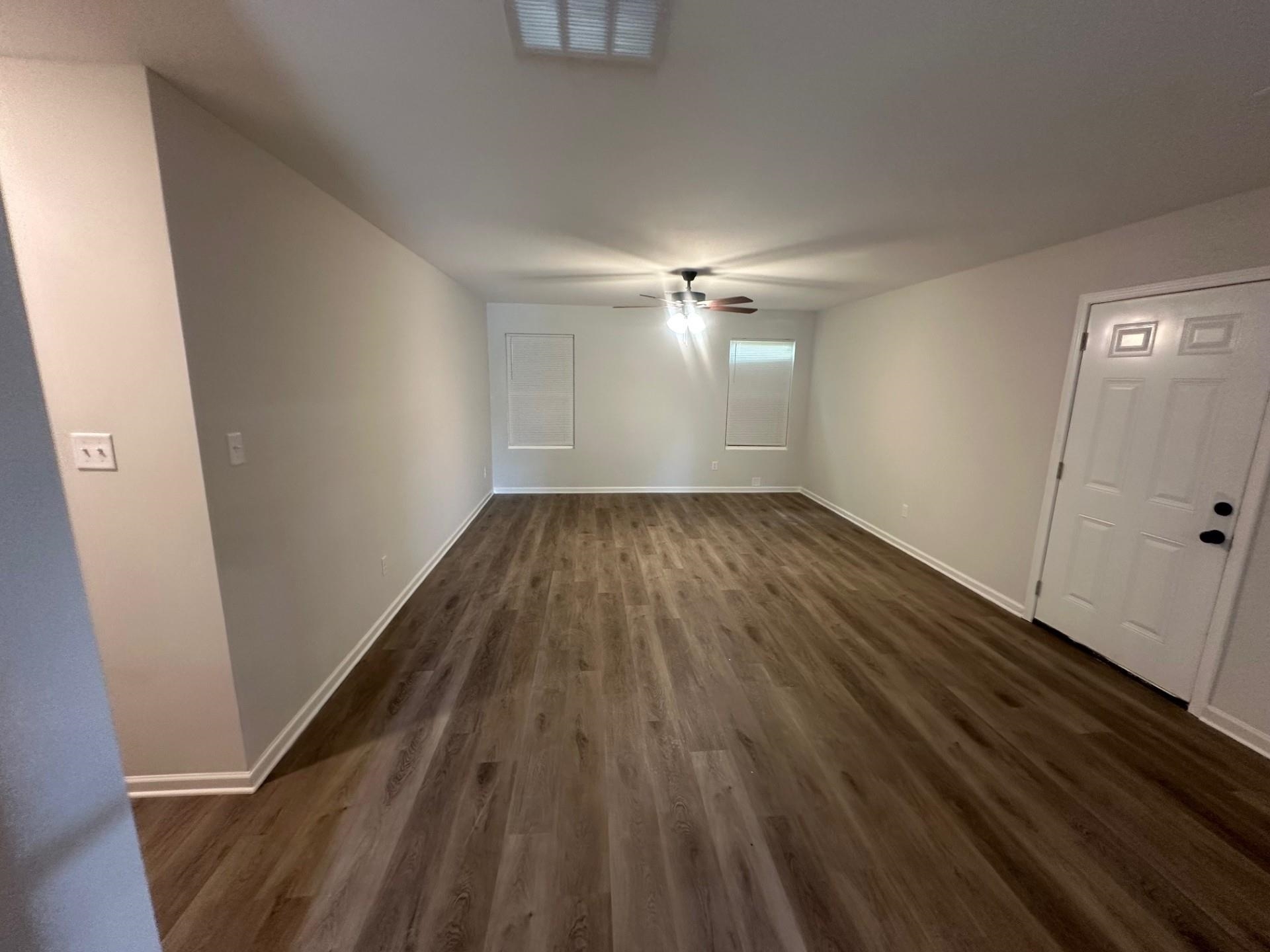 2585 Callie Road Memphis, TN 38127 - Photo 5 of 13 Unfurnished living room featuring baseboards, visible vents, dark wood-style floors, and ceiling fan