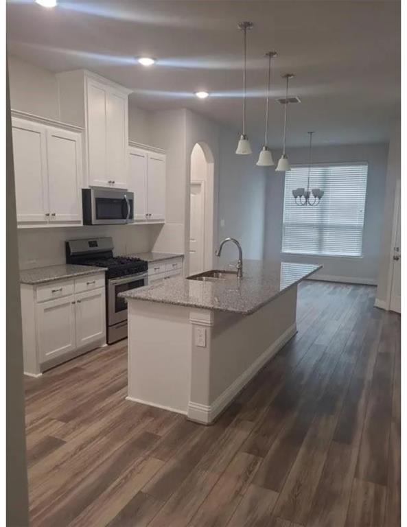 337 Eagle Ridge Road Forney, TX 75126 - Photo 2 of 16 a kitchen with granite countertop a stove and a sink