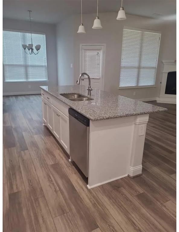 337 Eagle Ridge Road Forney, TX 75126 - Photo 16 of 16 a kitchen with granite countertop a sink and a wooden floor