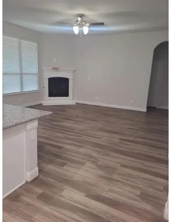a kitchen with granite countertop a sink and a wooden floor