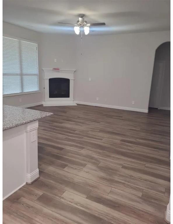 337 Eagle Ridge Road Forney, TX 75126 - Photo 3 of 16 a view of an empty room with wooden floor and a window