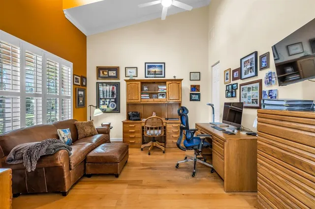 a livingroom with workspace and a window