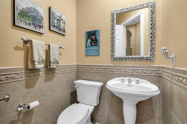 a bathroom with a sink mirror and toilet