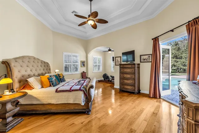 a bedroom with furniture and a flat screen tv