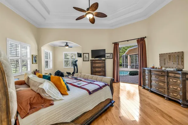 a bedroom with a bed and wooden floors