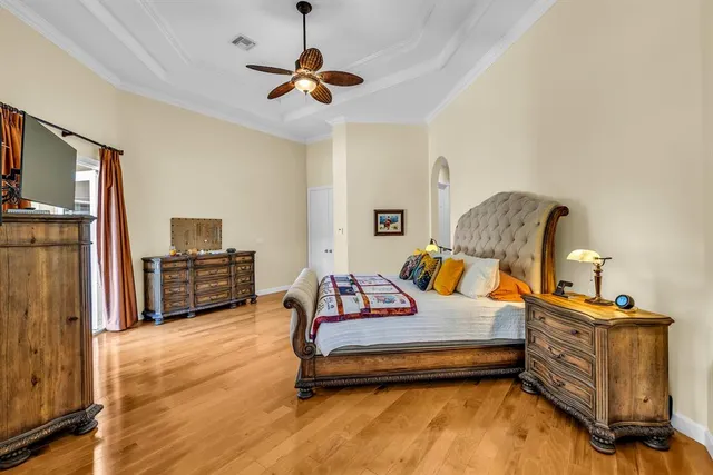 a bedroom with furniture and wooden floor