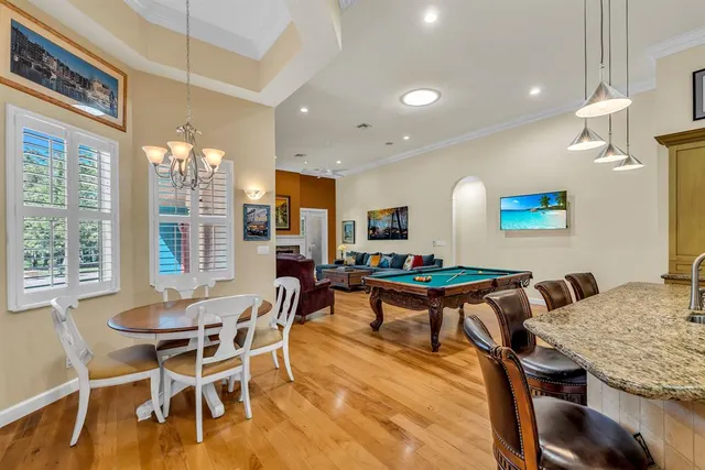 a living room with dining room and wooden floor