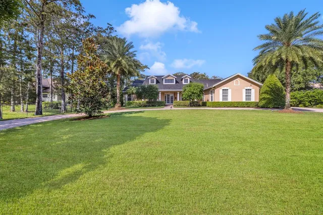 a front view of house with yard and green space