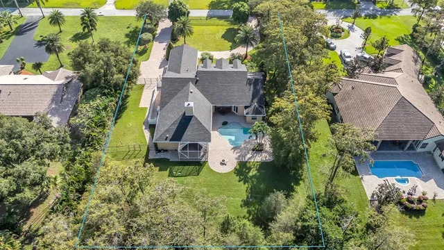 an aerial view of a house with garden space and street view