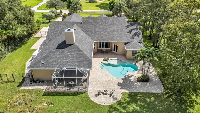 an aerial view of a house with a yard