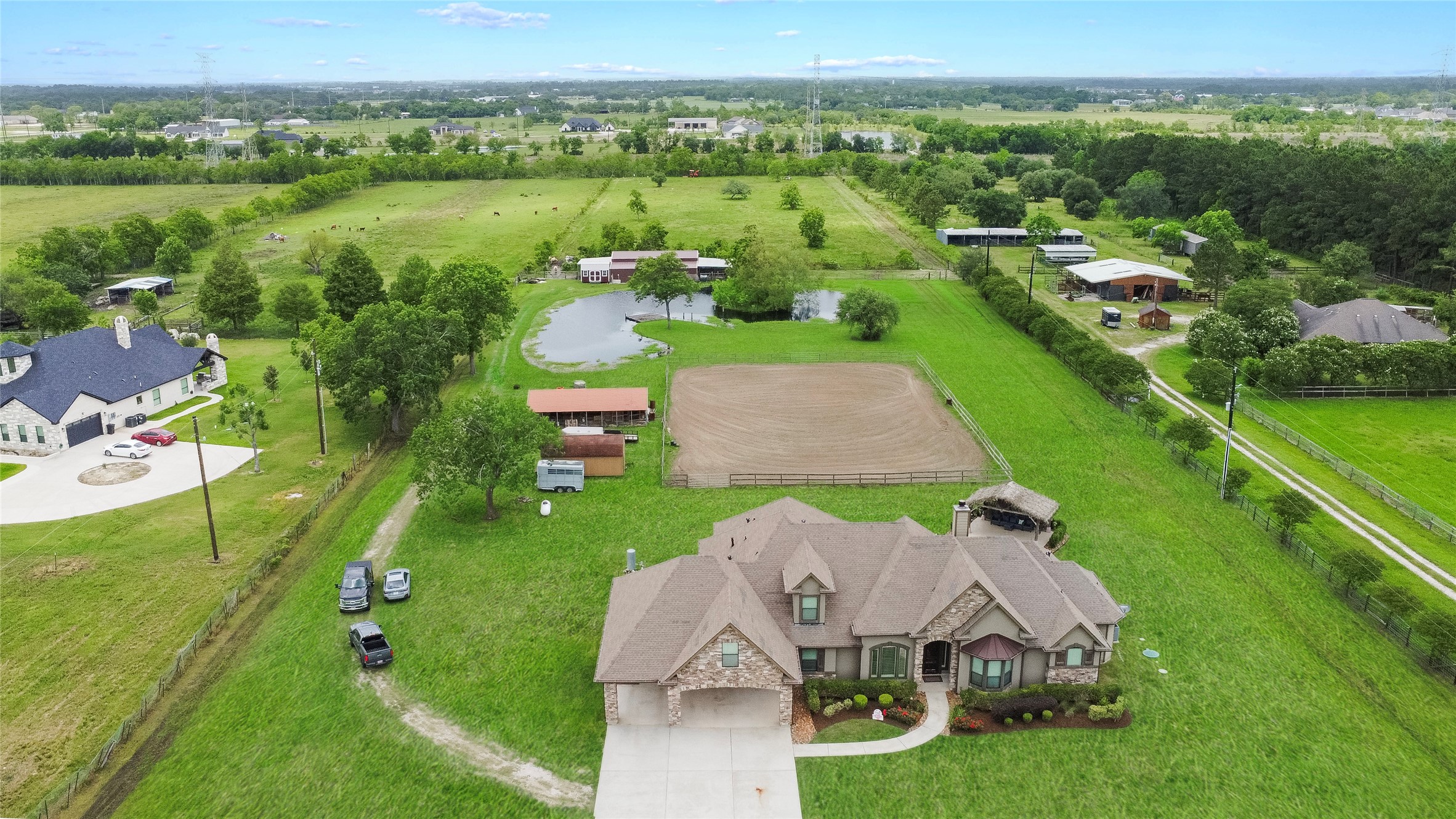 an aerial view of residential houses with outdoor space and trees