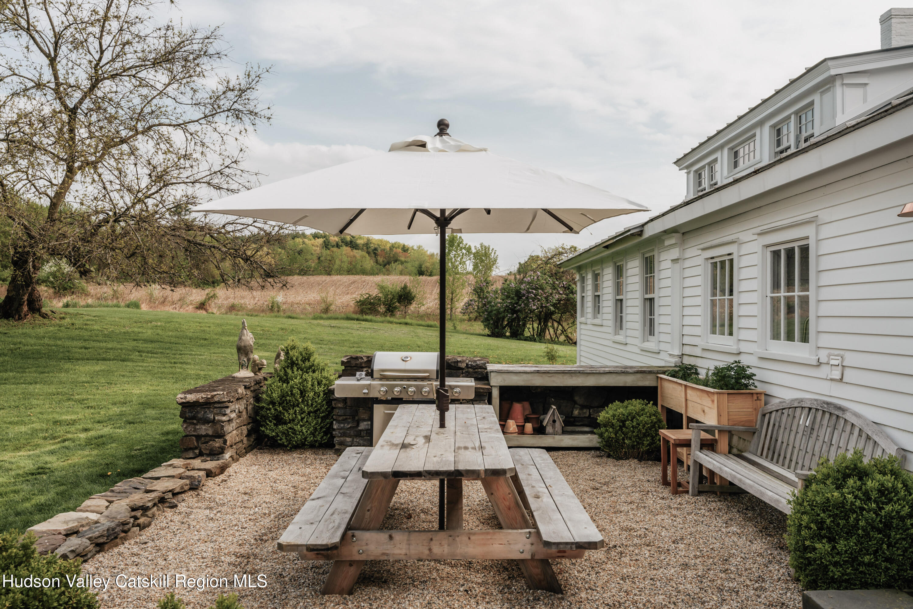 433 Rapp Road Valatie, NY 12184 - Photo 27 of 61 a view of a patio with couches table and chairs and potted plants