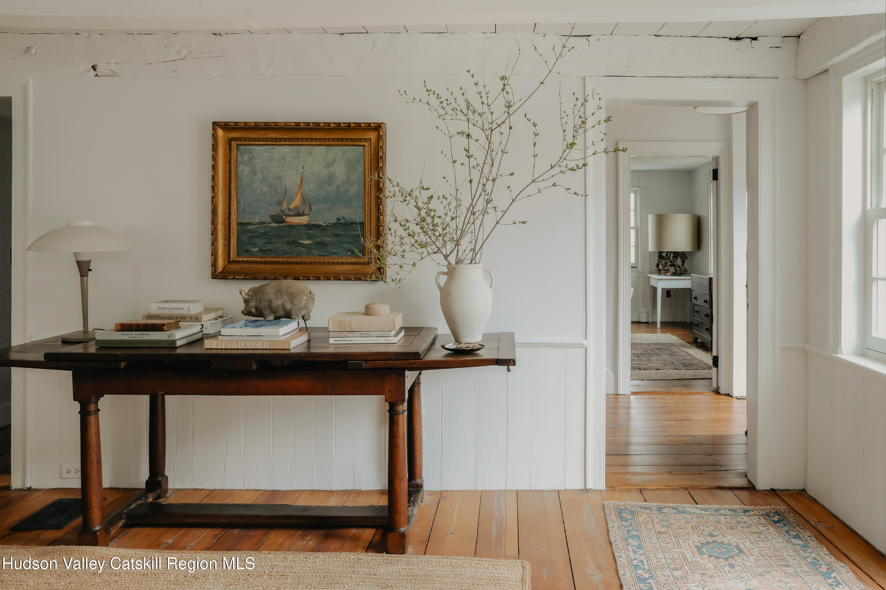 433 Rapp Road Valatie, NY 12184 - Photo 7 of 61 a view of a hallway with paintings on the wall