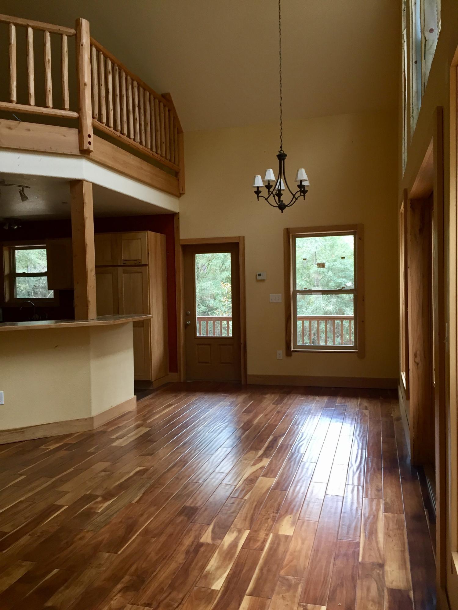 5960 Old Hickory Road Crestview, FL 32539 - Photo 4 of 43 an empty room with wooden floor a ceiling fan and windows