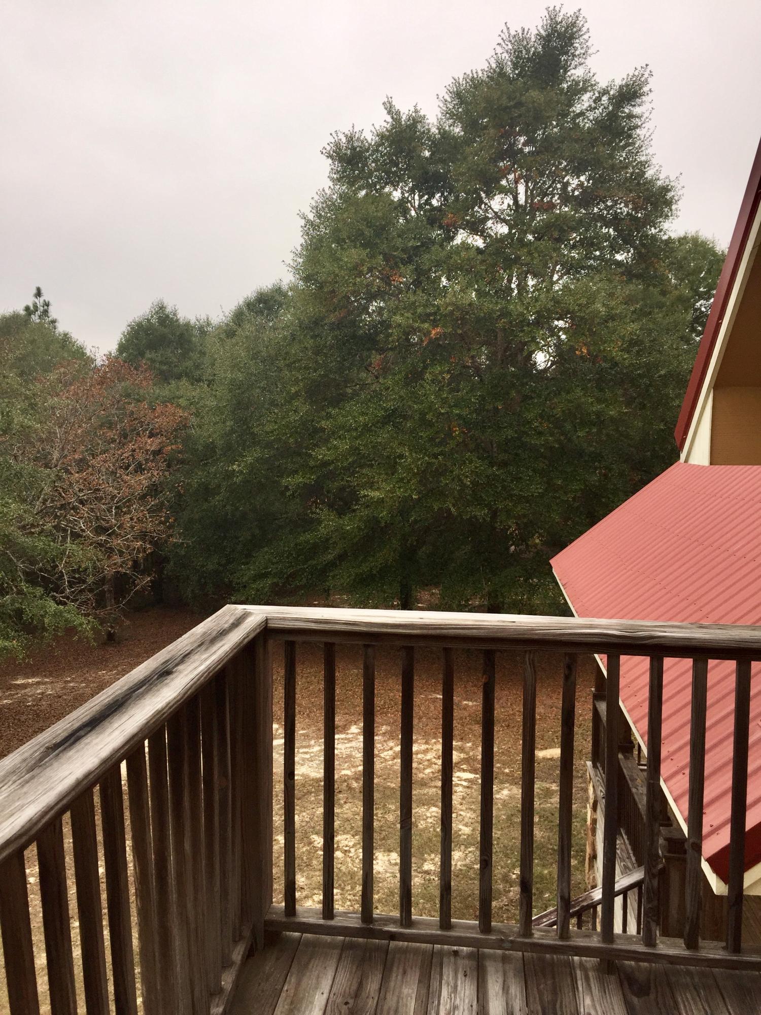 5960 Old Hickory Road Crestview, FL 32539 - Photo 39 of 43 a balcony with trees in front of it