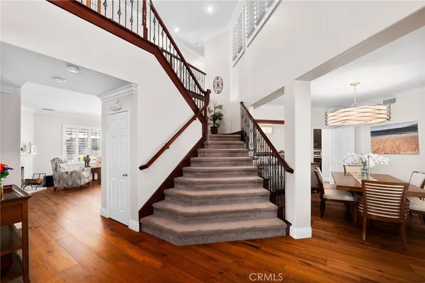a dining room with furniture a chandelier and wooden floor