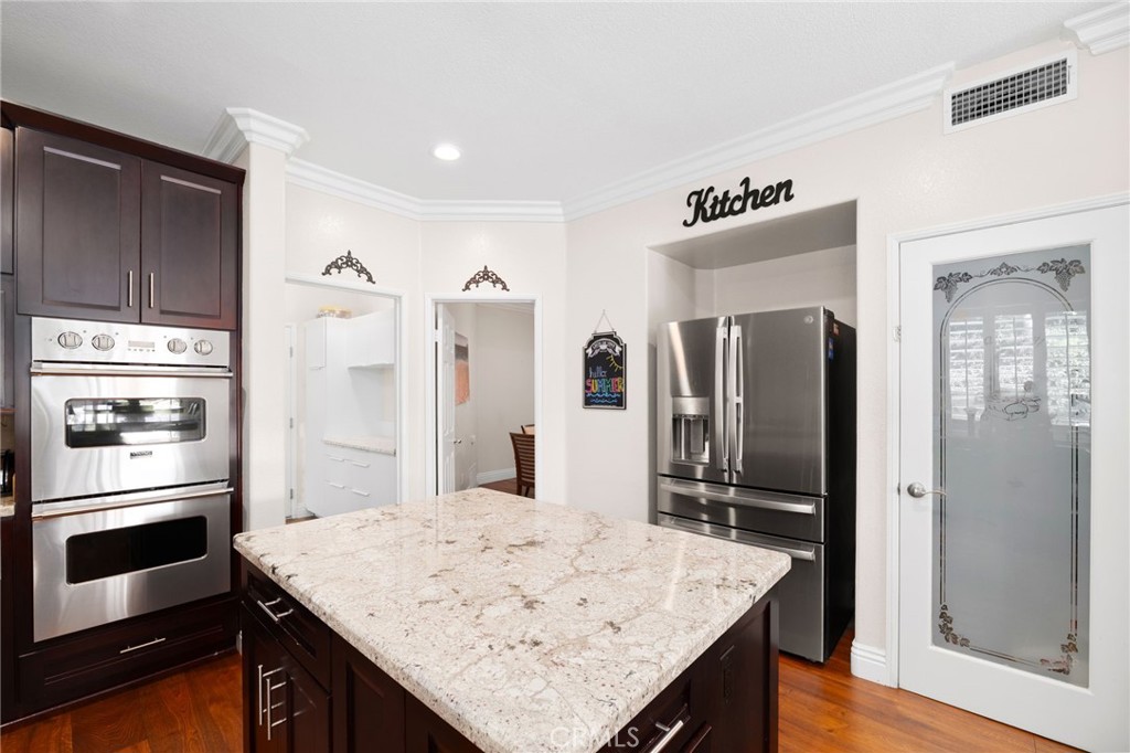 12759 East Rancho Estates Place Rancho Cucamonga, CA 91739 - Photo 26 of 69 a kitchen with stainless steel appliances kitchen island granite countertop a refrigerator and stove