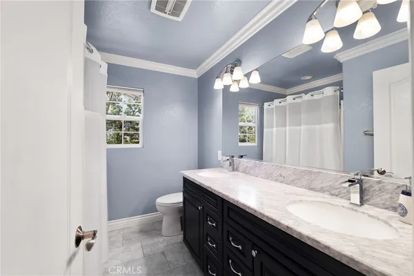 an aerial view of a house with a yard and garden