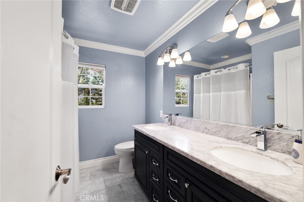 12759 East Rancho Estates Place Rancho Cucamonga, CA 91739 - Photo 46 of 69 a bathroom with a granite countertop sink a toilet and a mirror
