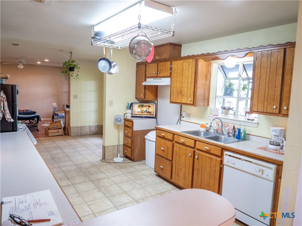 6611 Tigre Road Beeville, TX 78102 - Photo 11 of 31 a kitchen with a sink cabinets and window
