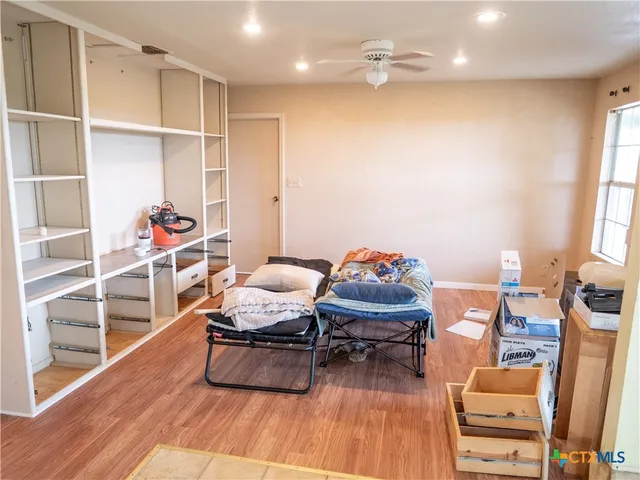 a room with furniture a rug and a window