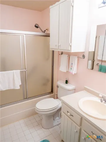 a white toilet sitting next to a bathroom sink