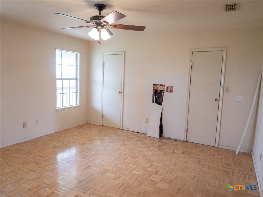 6611 Tigre Road Beeville, TX 78102 - Photo 20 of 31 a view of a big room with chandelier fan and windows