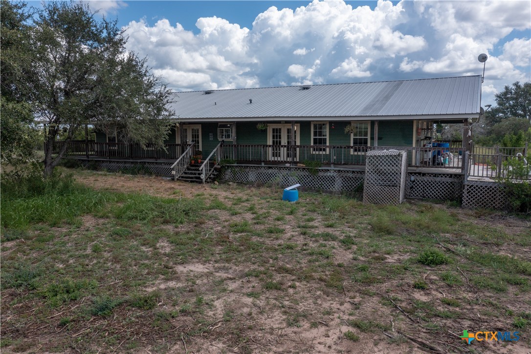 6611 Tigre Road Beeville, TX 78102 - Photo 2 of 31 a front view of a house with garden