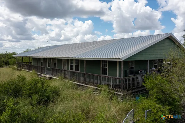 a view of house with pool and garden