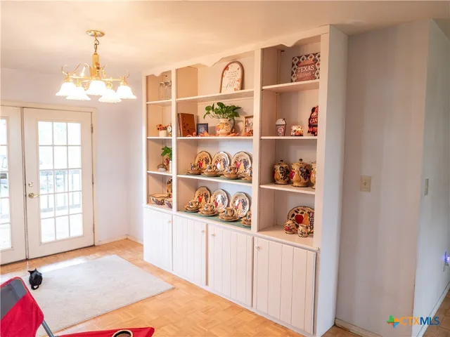 a view of a kitchen with shelves
