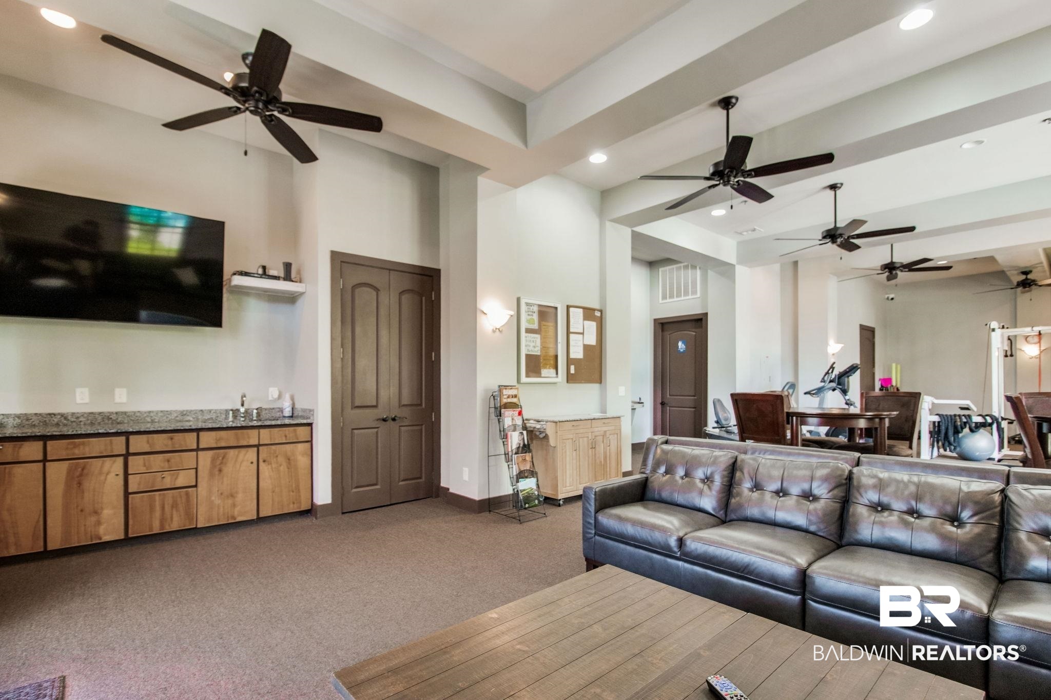 1430 Regency Road, Unit I201 Gulf Shores, AL 36542 - Photo 34 of 34 Living room with ceiling fan and carpet