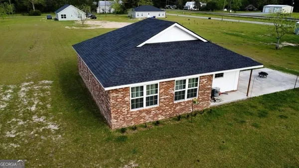 a aerial view of a house with swimming pool having outdoor seating