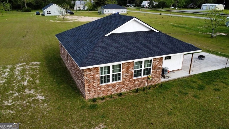 a aerial view of a house with swimming pool having outdoor seating