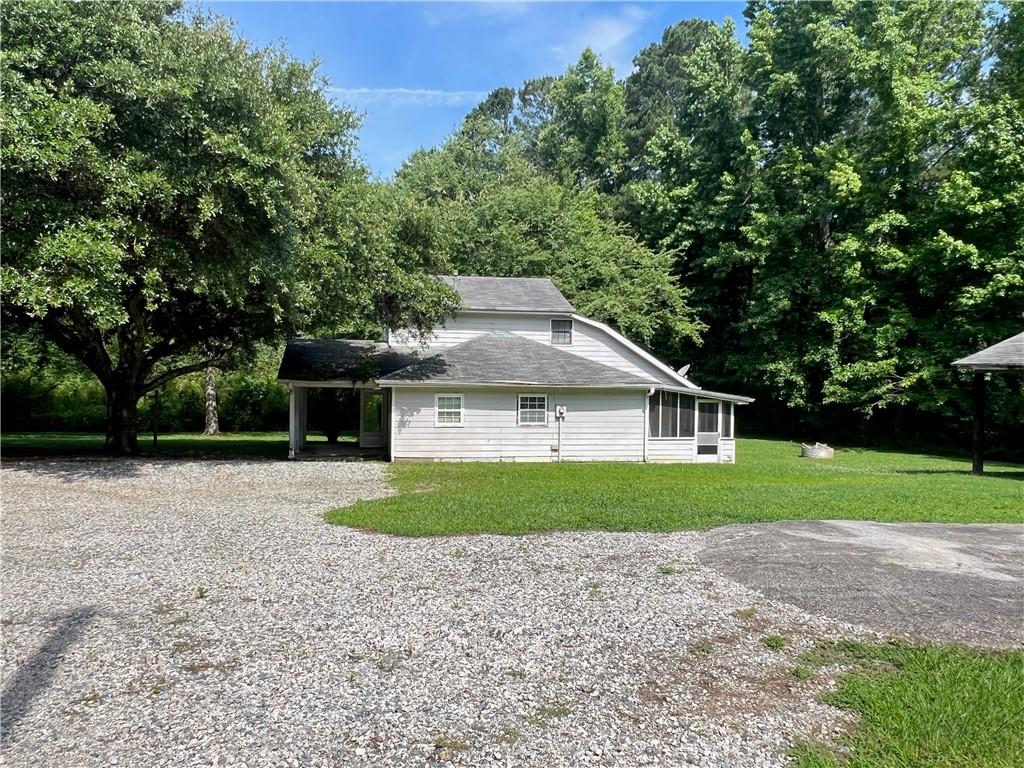 340 Womack Avenue Dallas, GA 30157 - Photo 28 of 29 a front view of a house with a yard and trees