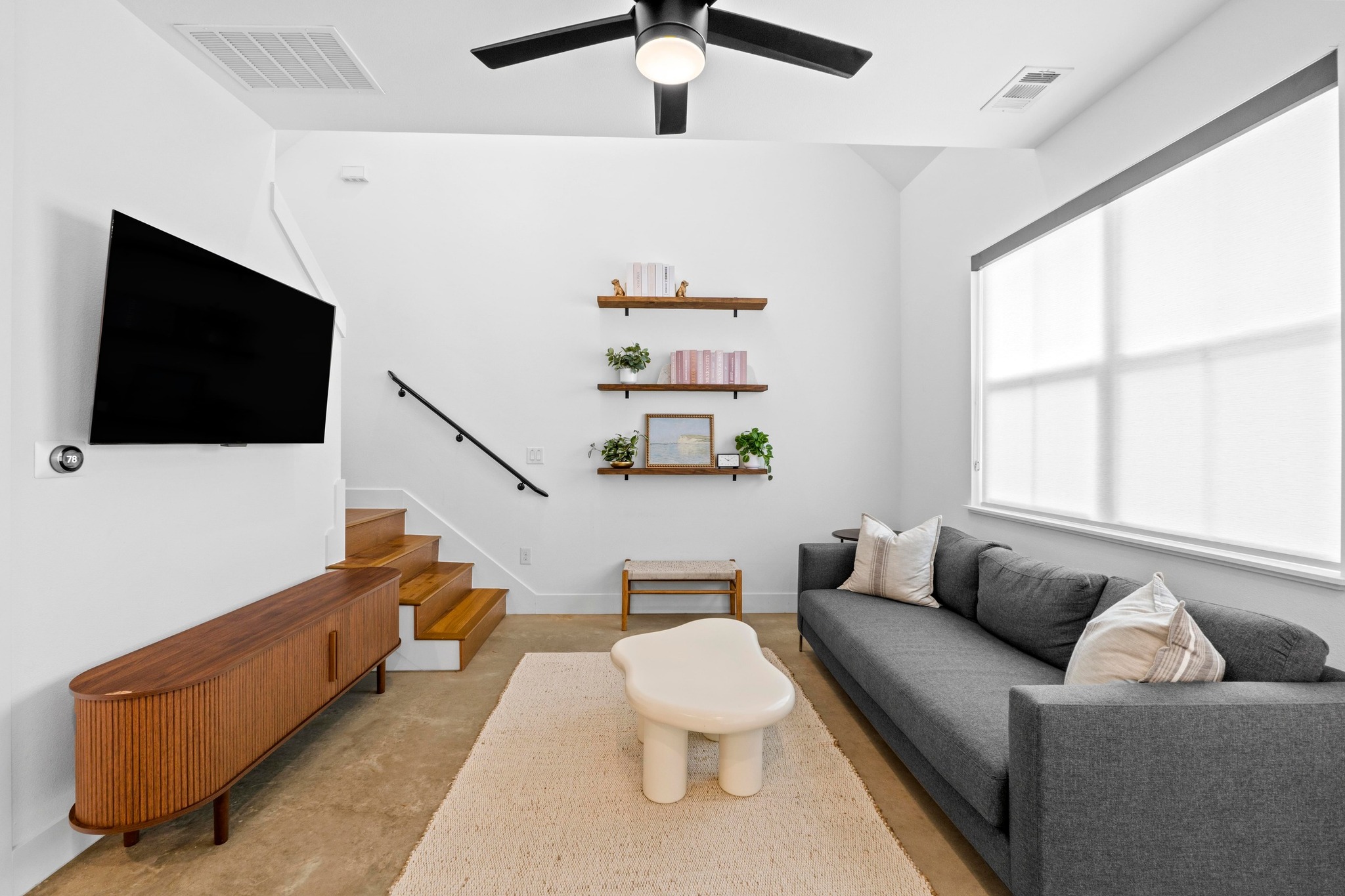 1706 Perez Street, Unit 2 Austin, TX 78721 - Photo 5 of 29 A living space offers a smooth transition from a comfortable lounging area to a sun-filled window.