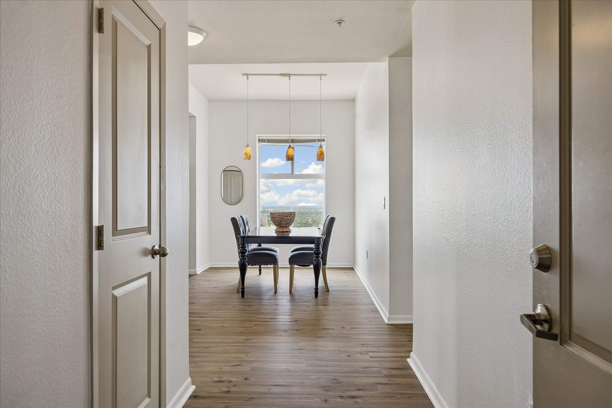 3505 Sage Road, Unit 2810 Houston, TX 77056 - Photo 2 of 26 a view of a hallway with wooden floor table and chairs