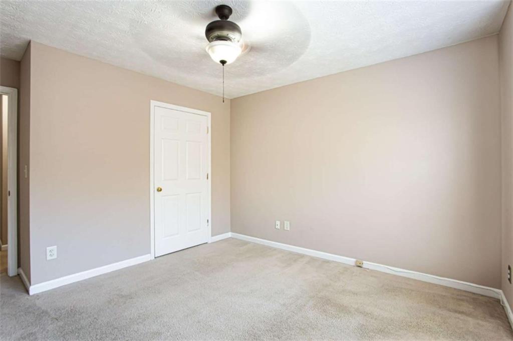 3721 Bogan Mill Road Northeast Buford, GA 30519 - Photo 32 of 58 an empty room with a fan