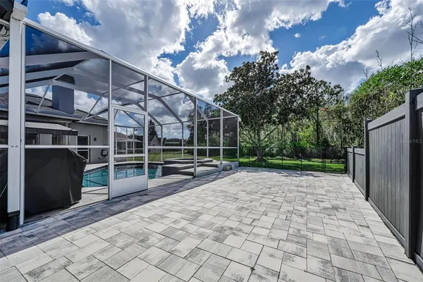 a large kitchen with kitchen island a stove a sink dishwasher and a refrigerator with wooden floor