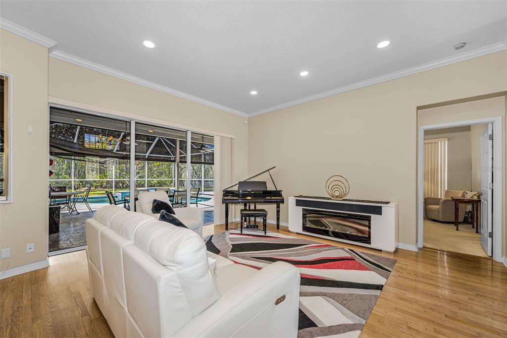 1151 Arlinbrook Drive Trinity, FL 34655 - Photo 24 of 69 a living room with furniture and a floor to ceiling window