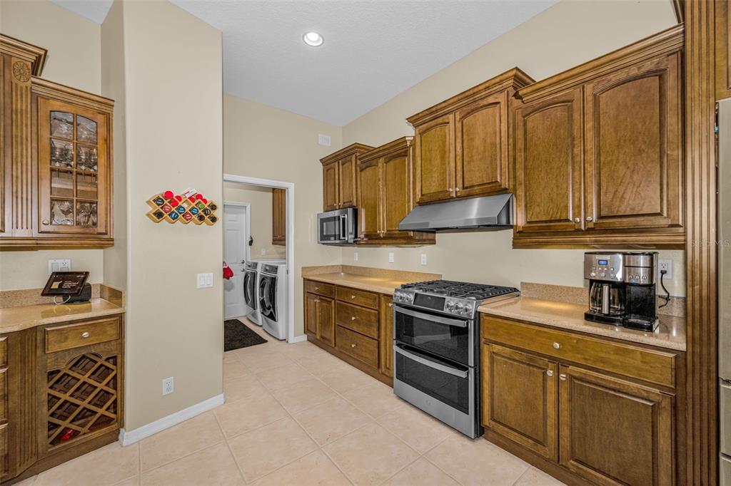1151 Arlinbrook Drive Trinity, FL 34655 - Photo 32 of 69 a kitchen with stainless steel appliances granite countertop a stove and a refrigerator
