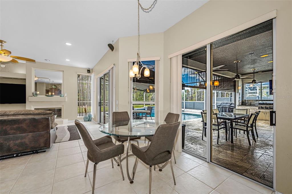 1151 Arlinbrook Drive Trinity, FL 34655 - Photo 35 of 69 a dining room with furniture a chandelier and wooden floor