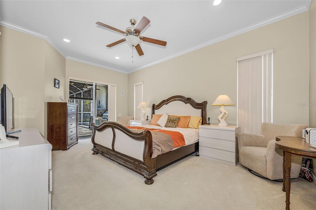 1151 Arlinbrook Drive Trinity, FL 34655 - Photo 42 of 69 a spacious bedroom with a bed and furniture