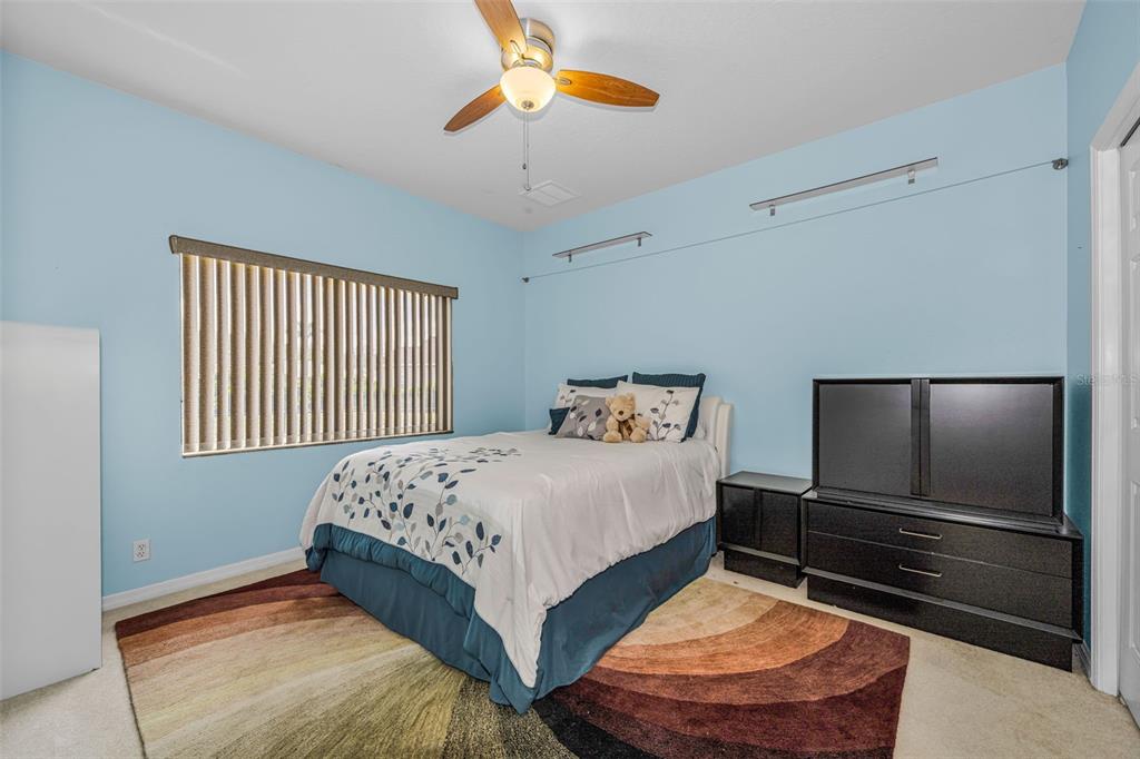 1151 Arlinbrook Drive Trinity, FL 34655 - Photo 53 of 69 a bedroom with a bed and a chandelier