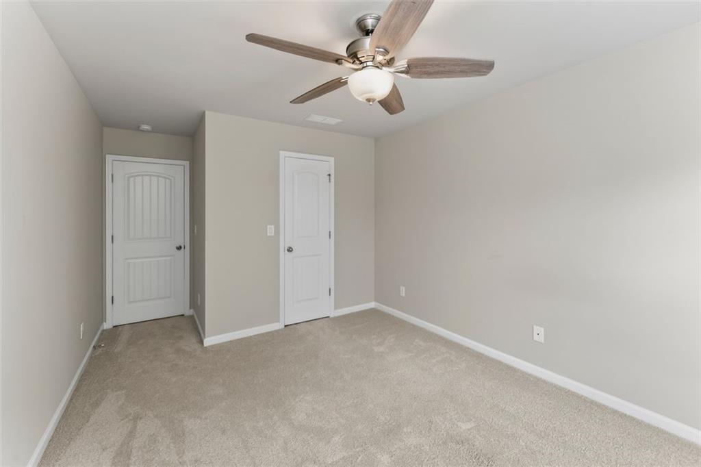 113 Tyson Woods Road Acworth, GA 30102 - Photo 31 of 37 an empty room with a chandelier fan and a ceiling fan